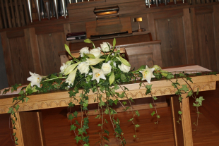 Blumengesteck in Weiss auf Altar